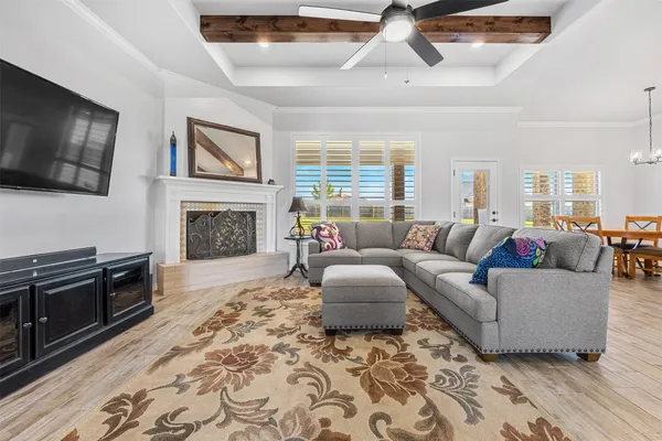 a living room with furniture a flat screen tv and a fireplace