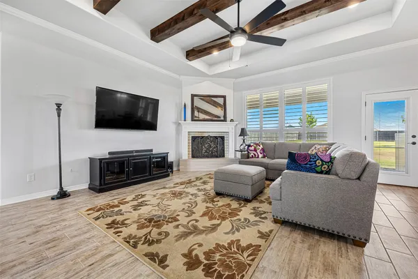 a living room with furniture a fireplace and a flat screen tv