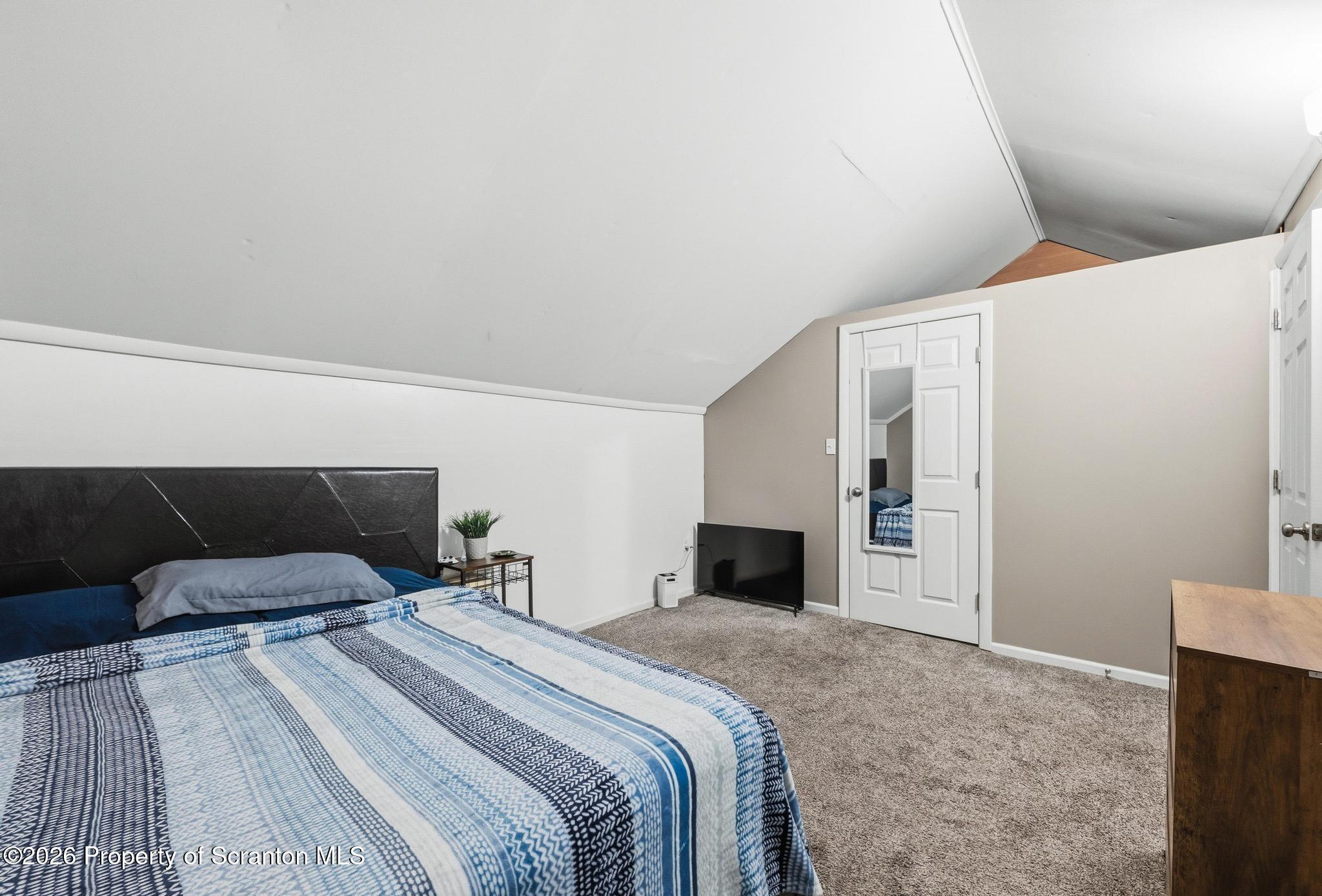 518 Prospect Avenue Scranton, PA 18505 - Photo 48 of 59 a bedroom with a large bed and a fireplace