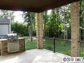 3200 Lake Shore Road South Denver, NC 28037 - Photo 12 of 16 a view of a deck with a floor to ceiling window and wooden fence