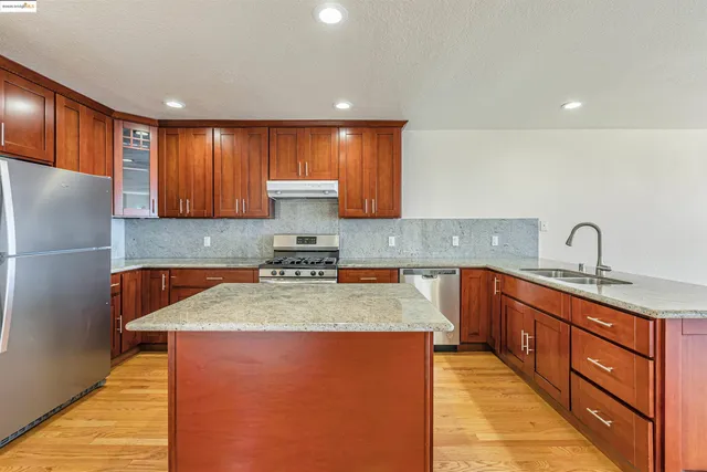 a kitchen with sink a refrigerator and cabinets