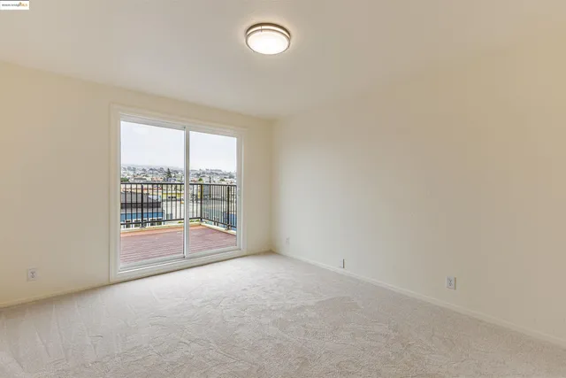 an empty room with a empty space and windows