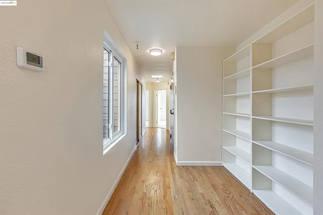 a view of hallway with wooden floor and entryway