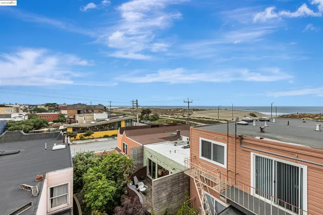 an aerial view of a residential houses with city view