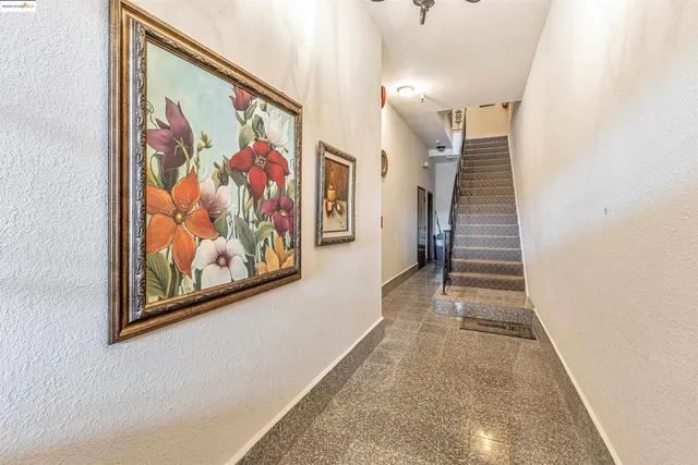 a view of a hallway with paintings on the wall