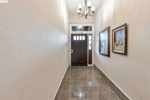 a view of a hallway with a chandelier
