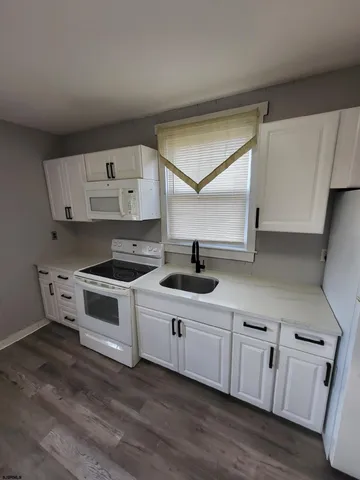 a kitchen with cabinets a sink and a stove
