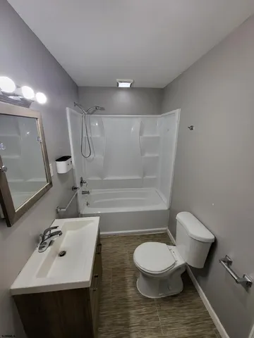 a bathroom with a sink mirror toilet and shower