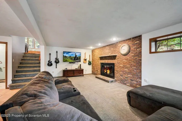 a view of a hallway with furniture and staircase