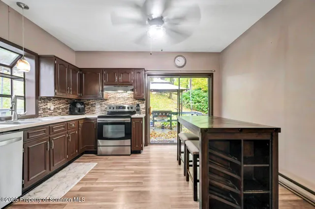a kitchen with stainless steel appliances granite countertop a stove and cabinets