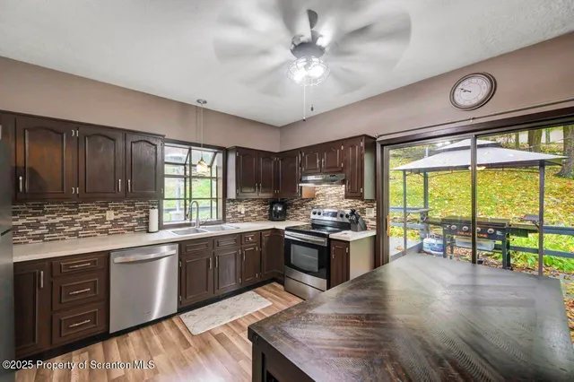 a kitchen with a sink a refrigerator and window