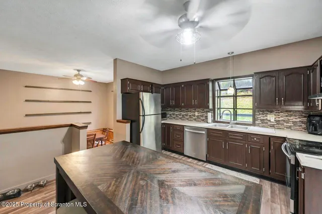 a kitchen with a stove a sink and a cabinets