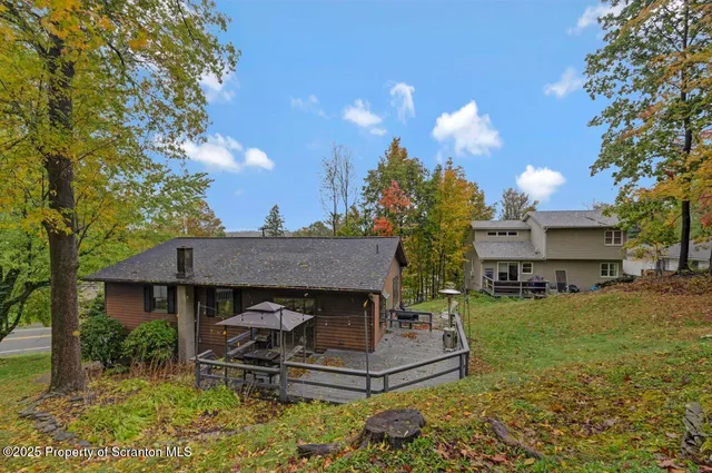 a view of a house with backyard porch and sitting area