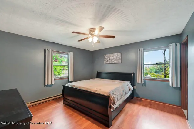 a bedroom with a large bed and a chandelier