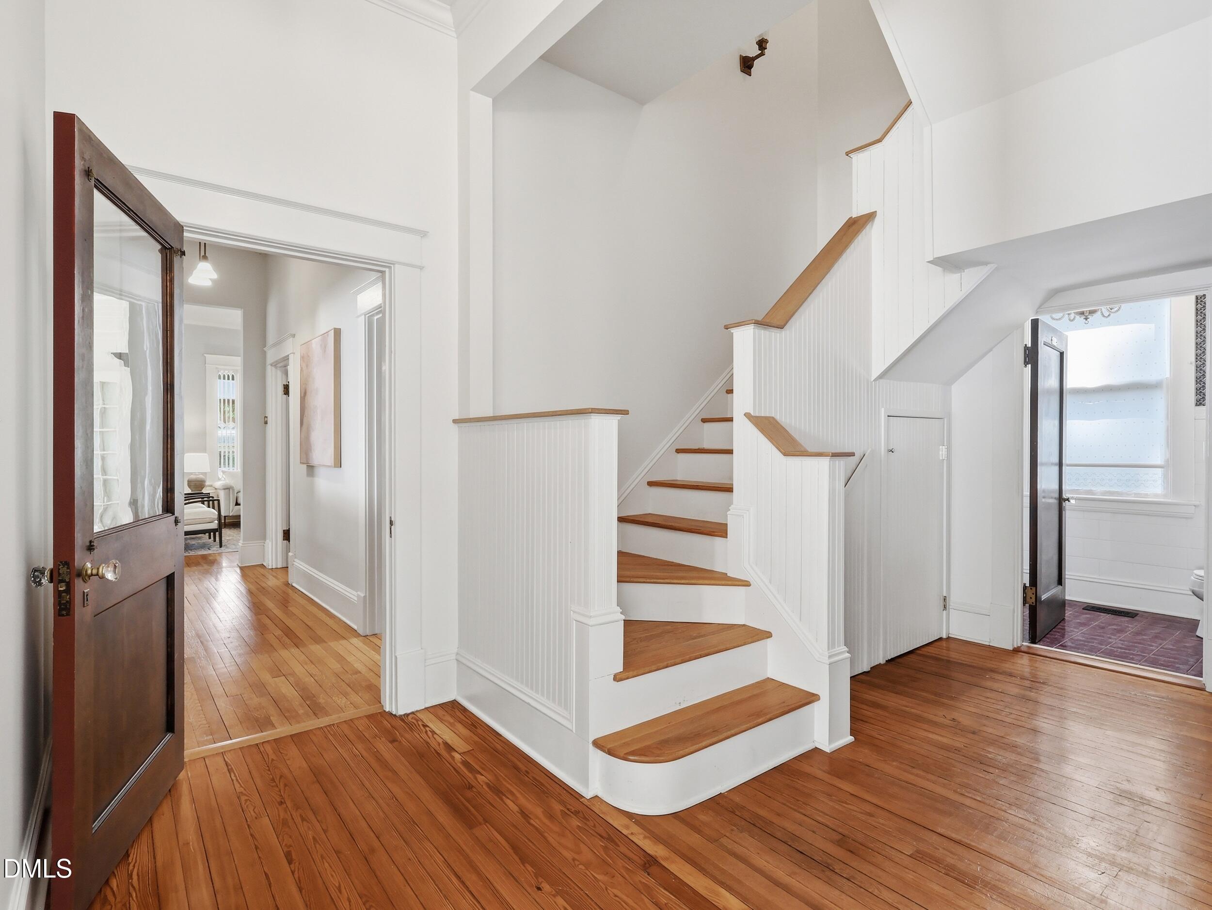 127 Forest Road Raleigh, NC 27605 - Photo 22 of 75 a view of a hallway view with wooden floor and staircase