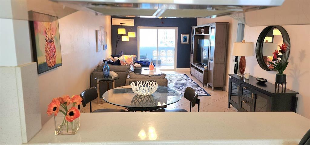 320 South Surf Road, Unit 704 Hollywood, FL 33019 - Photo 6 of 20 a living room with furniture and a wooden floor