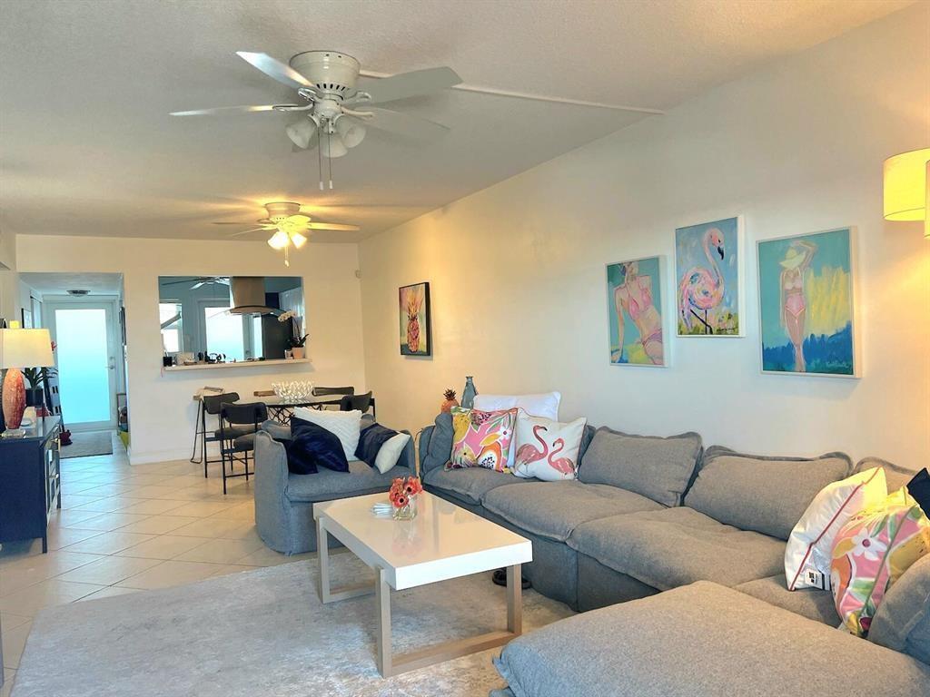 320 South Surf Road, Unit 704 Hollywood, FL 33019 - Photo 8 of 20 a living room with furniture kitchen view and a chandelier
