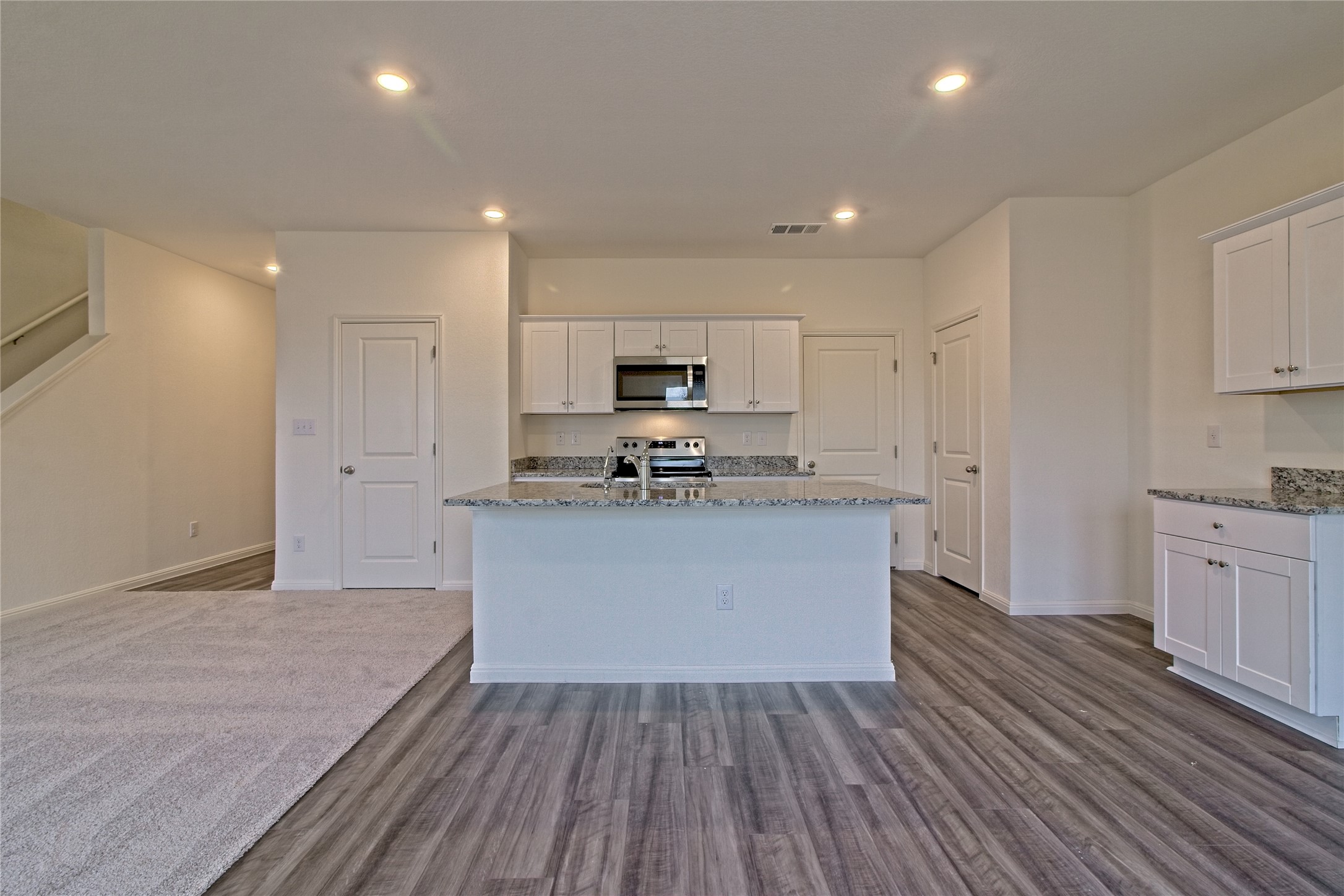 109 Gemsbok Road Hutto, TX 78634 - Photo 12 of 30 a large kitchen with stainless steel appliances granite countertop a stove a sink and a refrigerator
