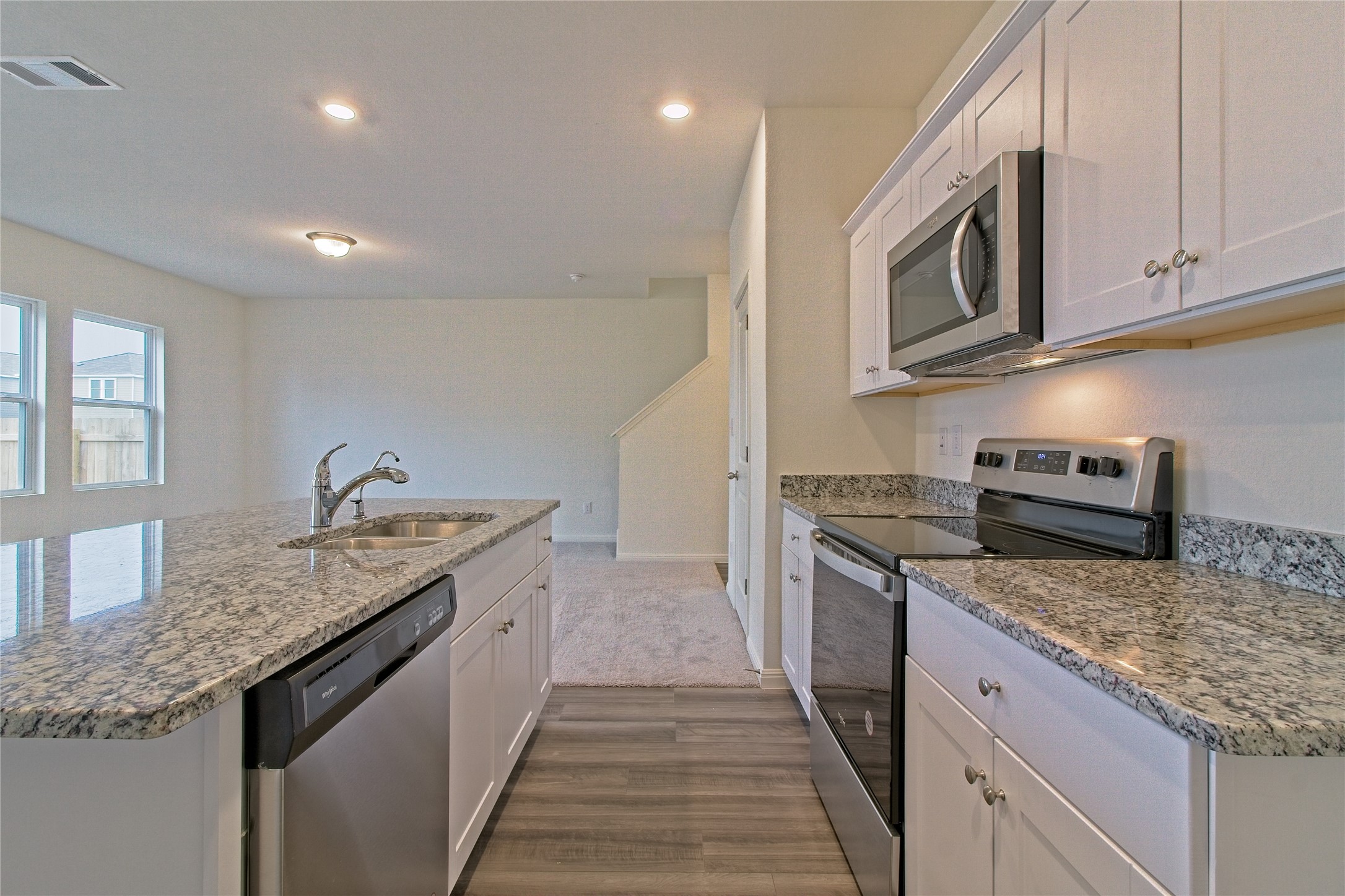 109 Gemsbok Road Hutto, TX 78634 - Photo 13 of 30 a kitchen with granite countertop stainless steel appliances and sink