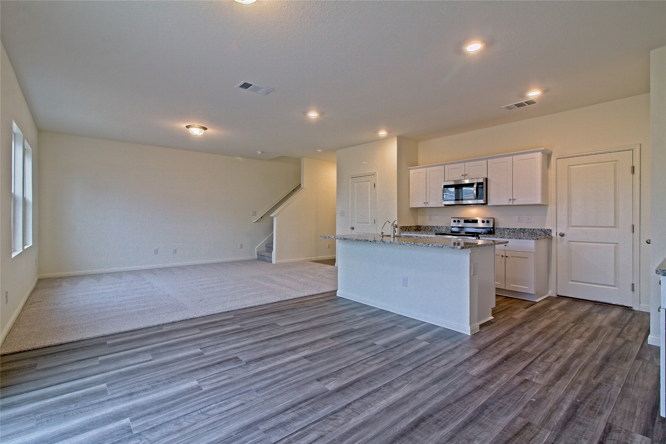 109 Gemsbok Road Hutto, TX 78634 - Photo 14 of 30 a kitchen with granite countertop a stove a sink and a refrigerator