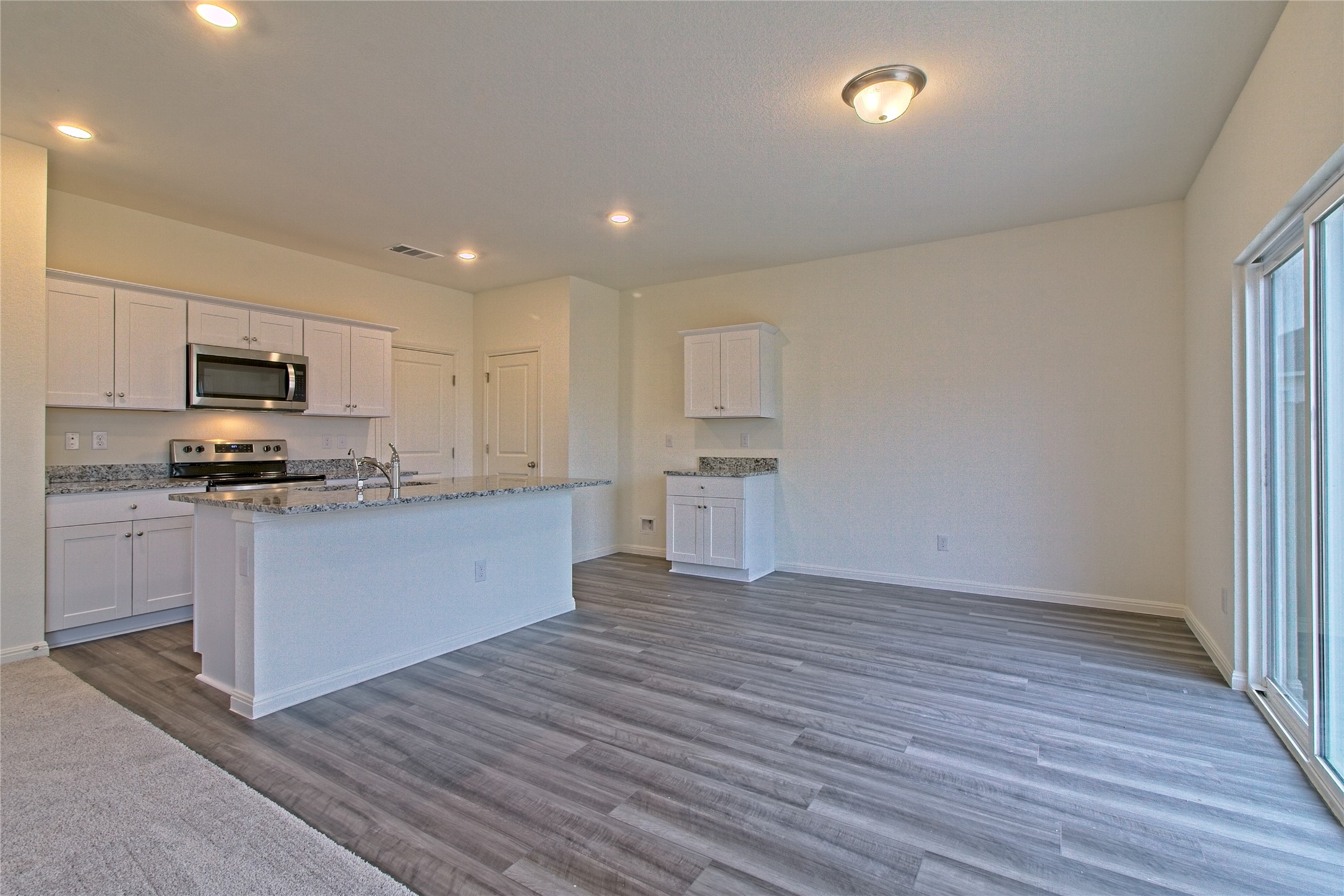 109 Gemsbok Road Hutto, TX 78634 - Photo 15 of 30 a kitchen with wooden floors and white appliances