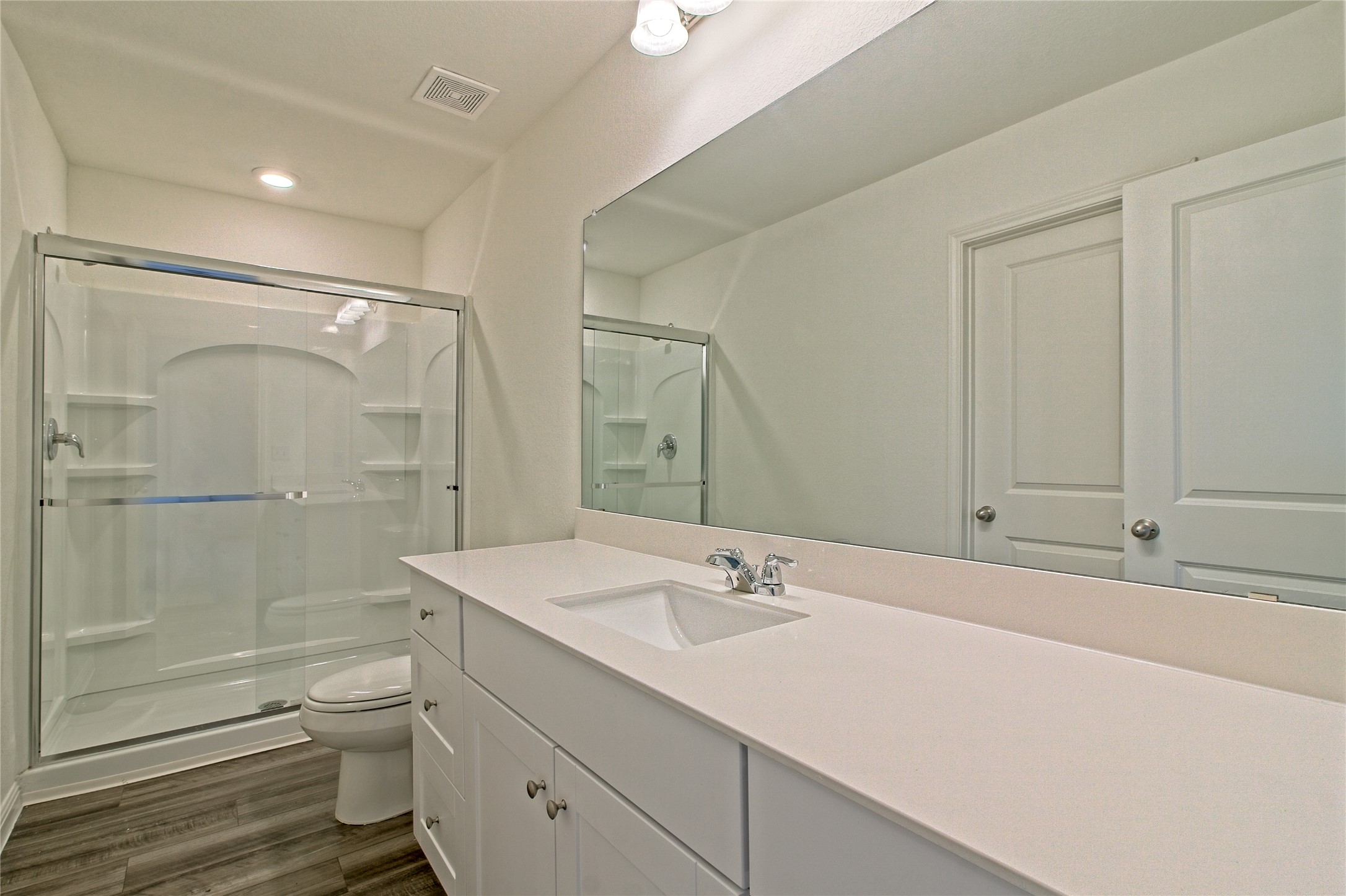 109 Gemsbok Road Hutto, TX 78634 - Photo 19 of 30 a bathroom with a shower sink vanity mirror and toilet