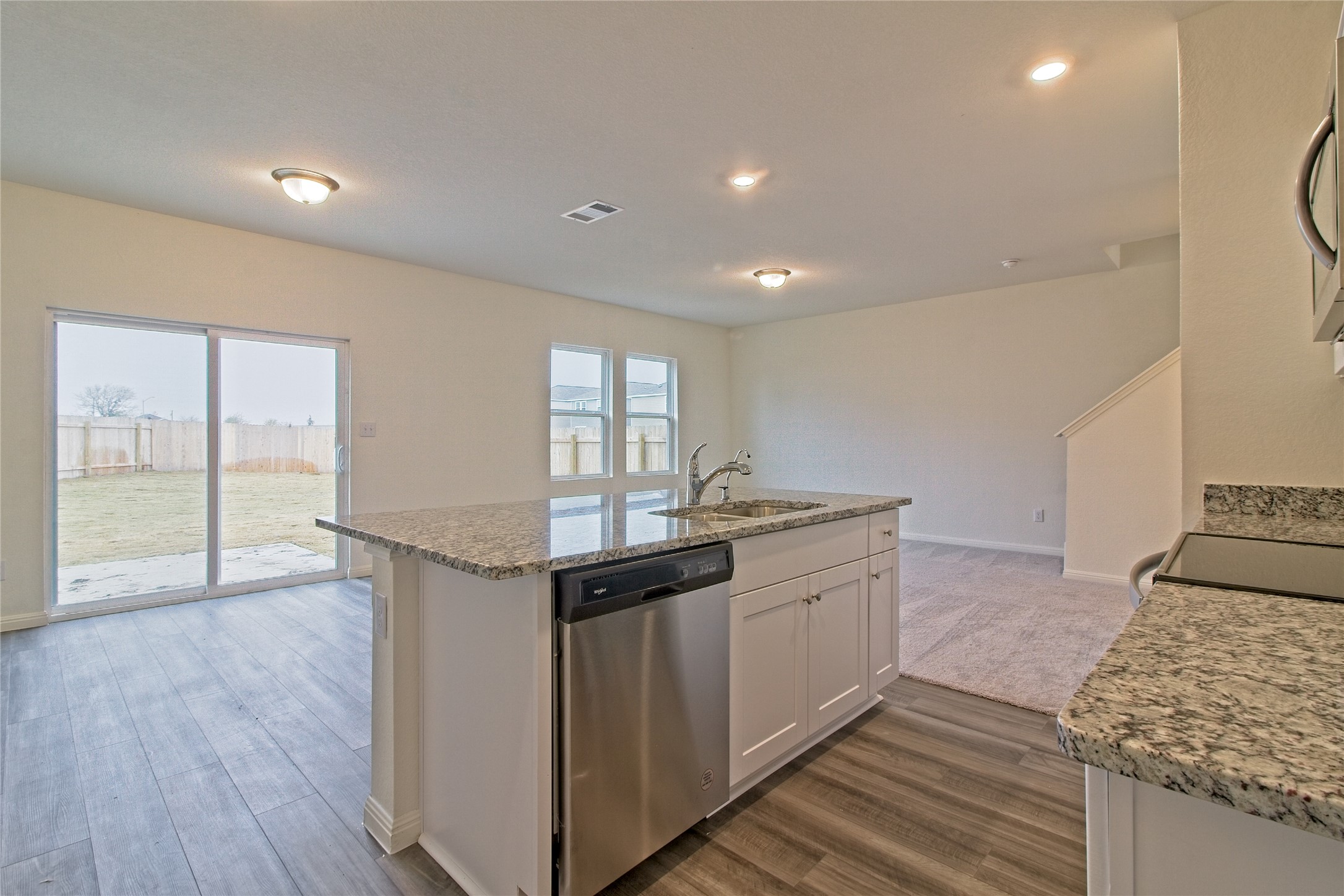 109 Gemsbok Road Hutto, TX 78634 - Photo 8 of 30 a kitchen with stainless steel appliances granite countertop a stove and a wooden floors