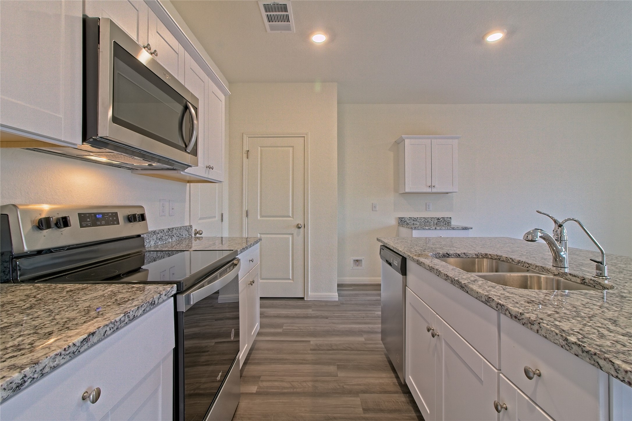 109 Gemsbok Road Hutto, TX 78634 - Photo 9 of 30 a kitchen with stainless steel appliances granite countertop a sink stove and microwave