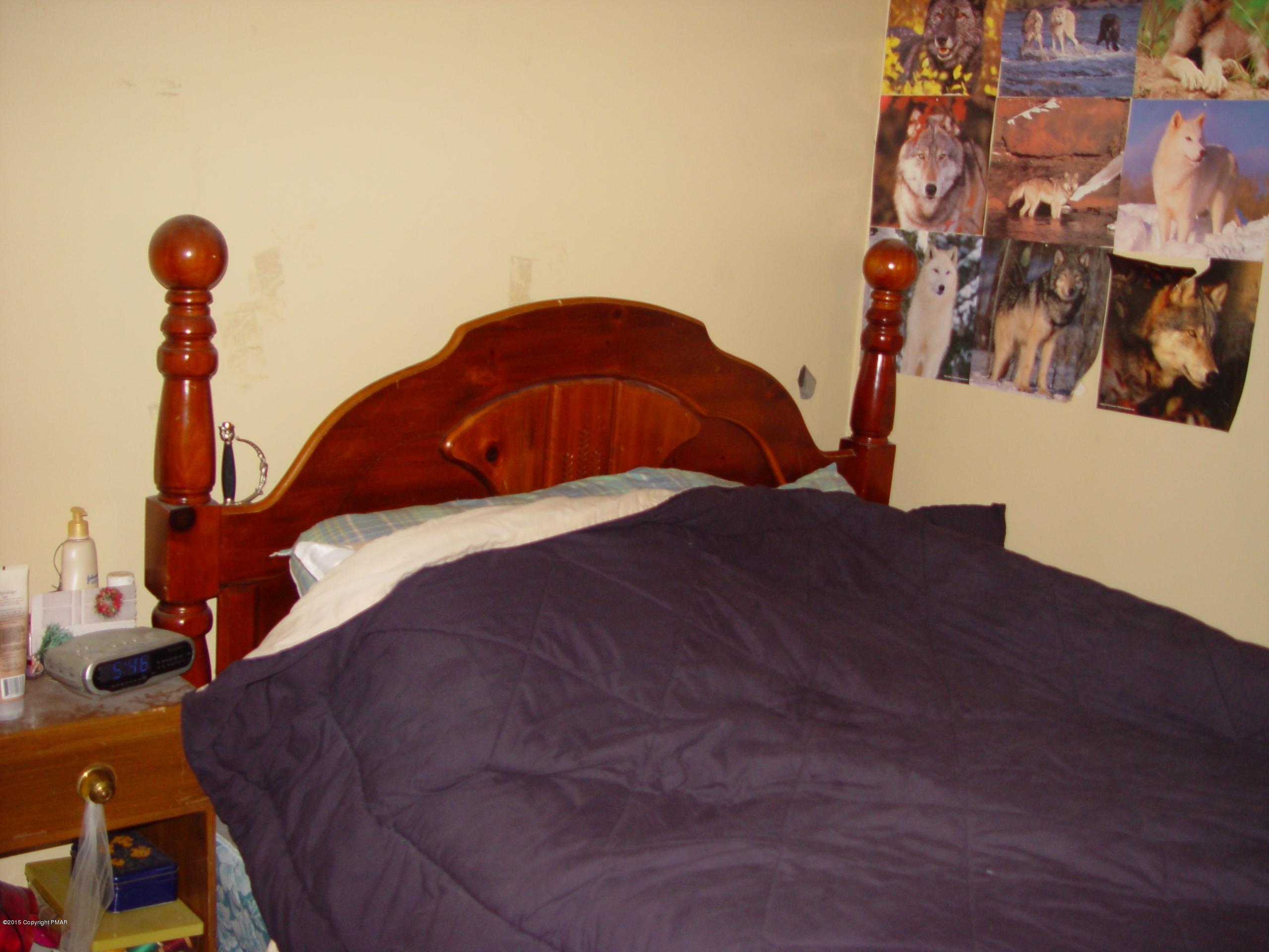 29 Old Post Road Tobyhanna, PA 18466 - Photo 11 of 16 a bed sitting in a bedroom next to a window