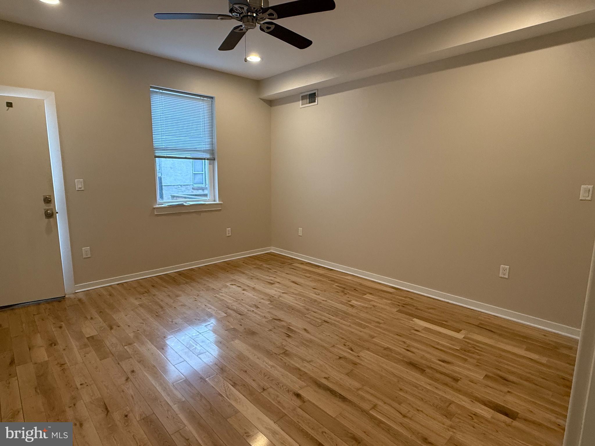 2542 Ellsworth Street, Unit A Philadelphia, PA 19146 - Photo 12 of 21 wooden floor in an empty room with a window