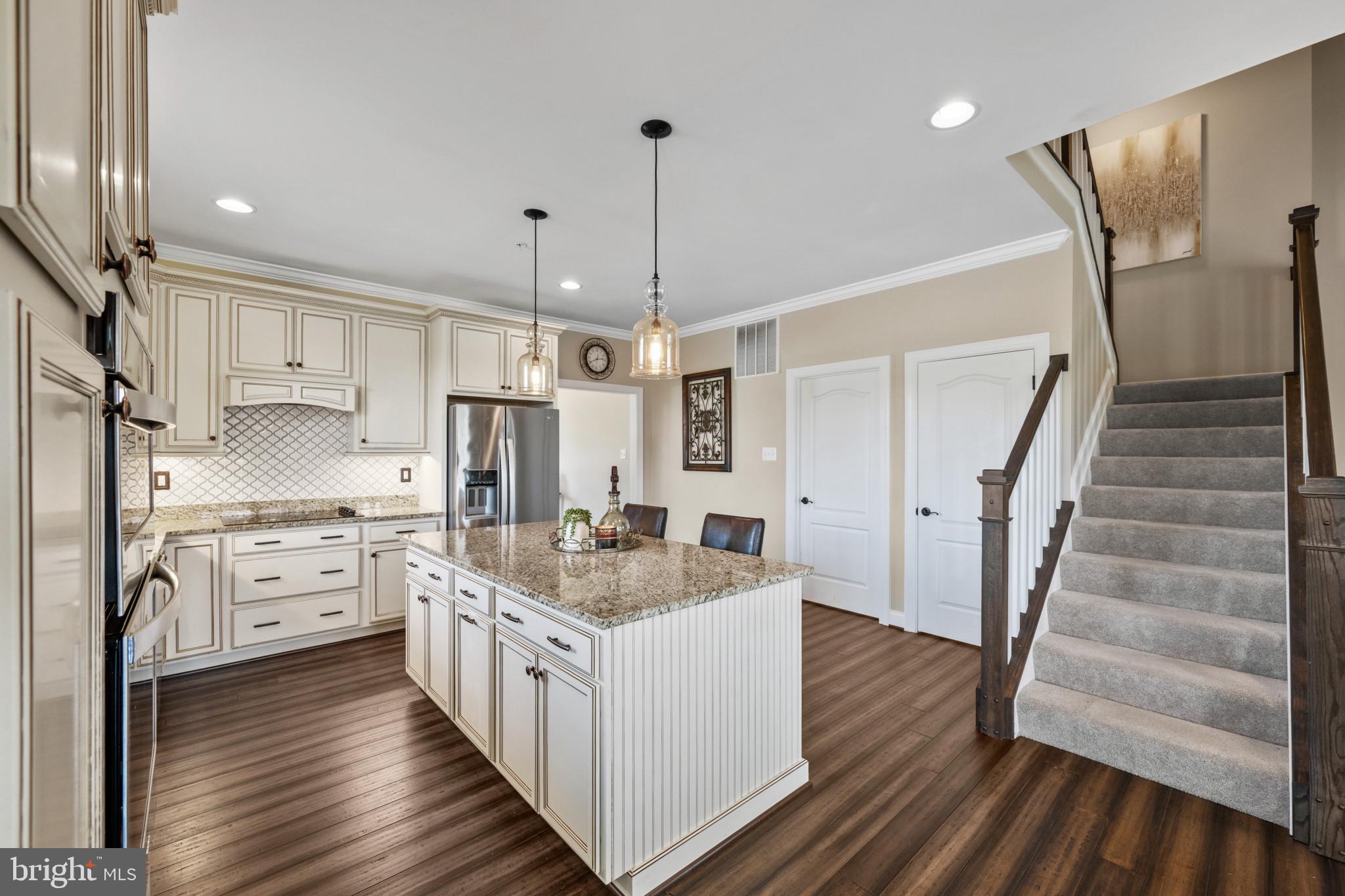 9736 Cross Road Perry Hall, MD 21128 - Photo 9 of 32 a kitchen with white cabinets sink and stainless steel appliances