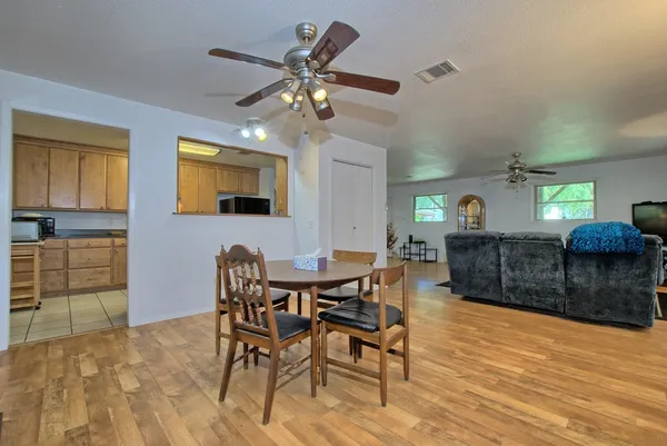 a view of a dining room with furniture and chandelier