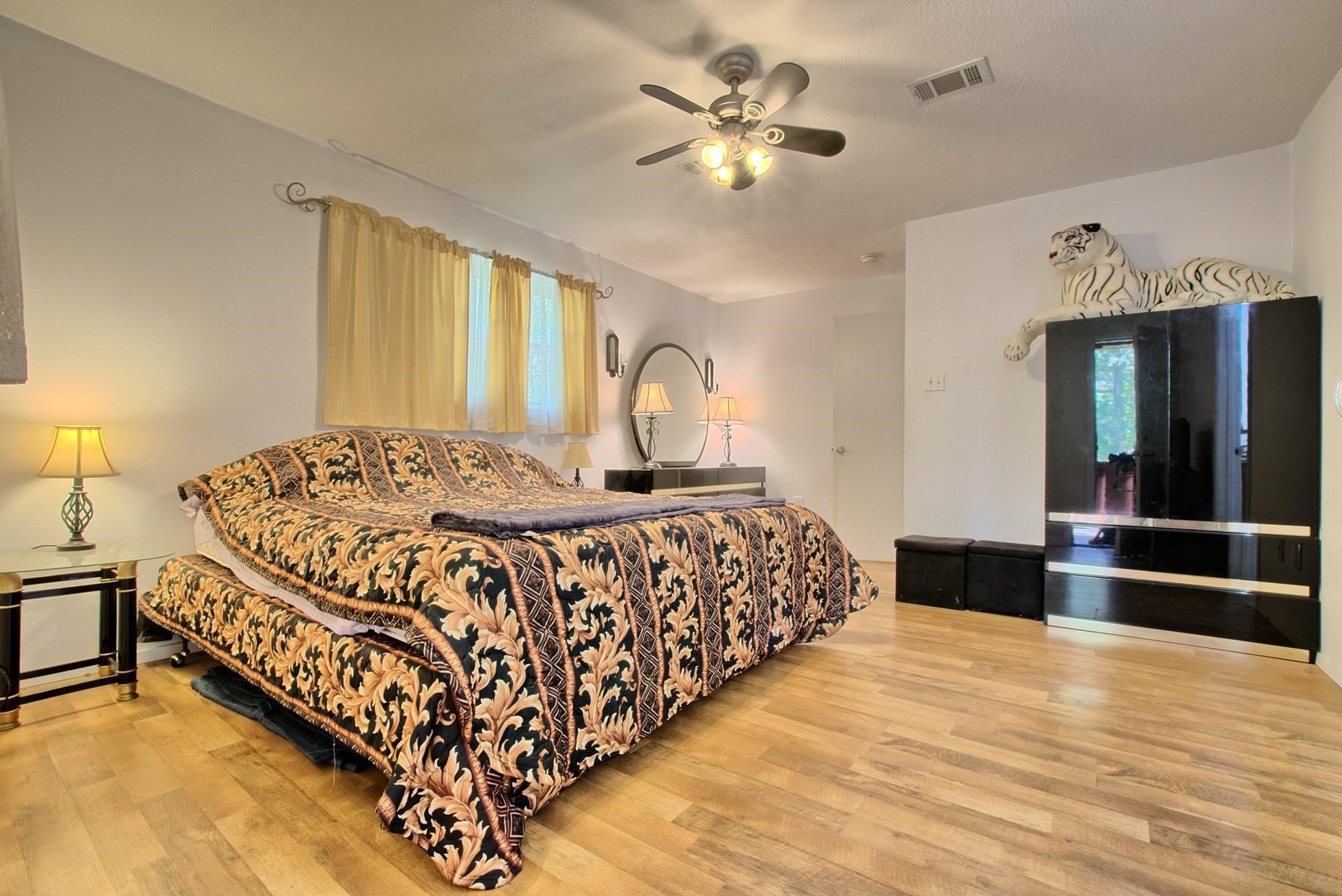 360 Oakhill Road Hemphill, TX 75948 - Photo 23 of 31 a bedroom with a bed and a chandelier