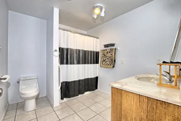 a bathroom with a sink a toilet and mirror