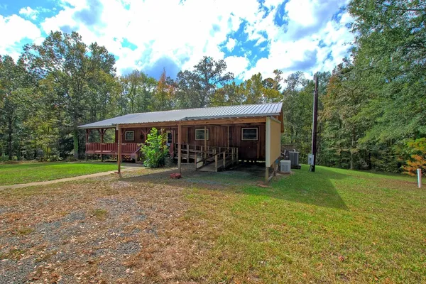 a view of a house with backyard porch and sitting area
