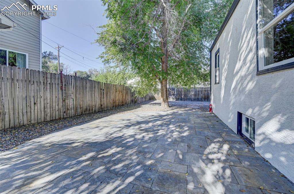 2459 East Willamette Avenue Colorado Springs, CO 80909 - Photo 17 of 19 a view of a backyard with wooden fence and large trees