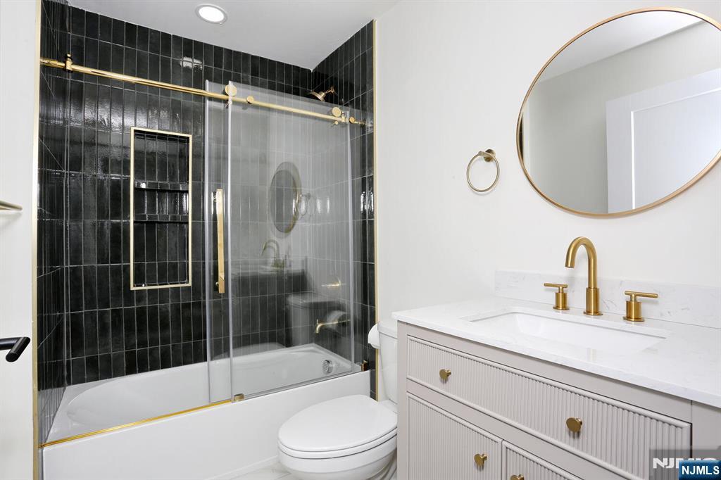 160 Terrace Street, Unit 2H Haworth, NJ 07641 - Photo 15 of 22 a bathroom with a sink a toilet and shower