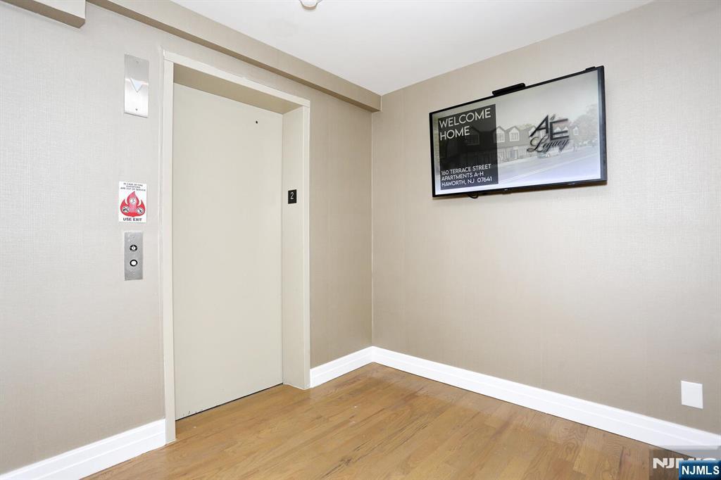 160 Terrace Street, Unit 2H Haworth, NJ 07641 - Photo 9 of 22 a view of hallway with wooden floor