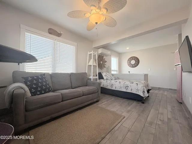 a bedroom with a bed couch and window