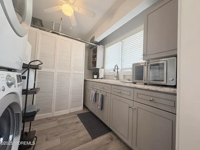 a kitchen with sink a microwave a refrigerator and cabinets