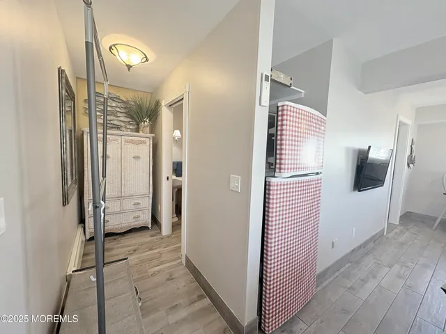 a view of a hallway with wooden floor