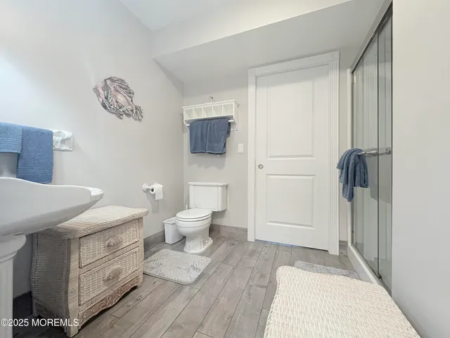 a bathroom with a sink a toilet and a shower