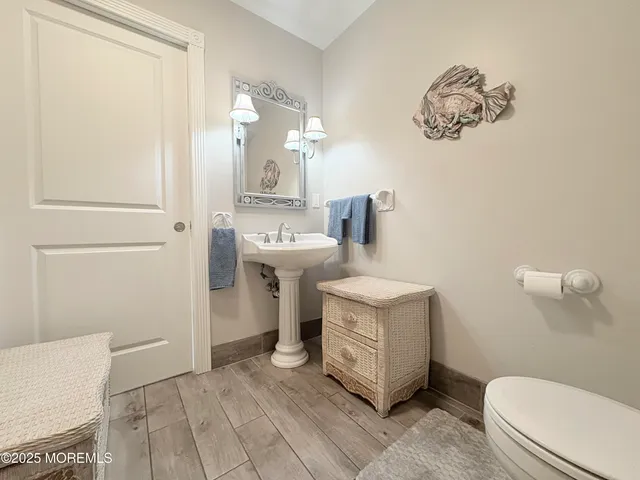 a bathroom with a sink a toilet and a mirror