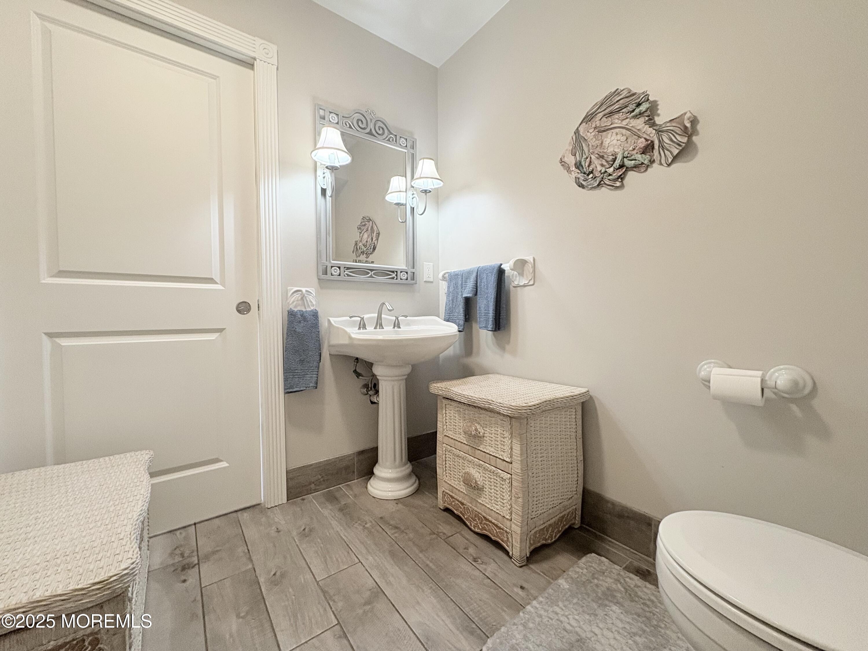 1203 Walter Boulevard Beach Haven West, NJ 08050 - Photo 8 of 11 a bathroom with a sink a toilet and a mirror