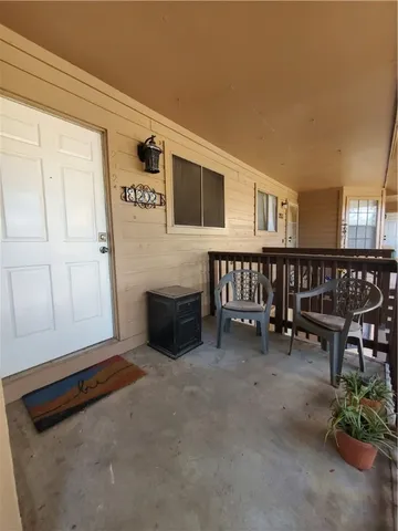 a living room with furniture and a dining table