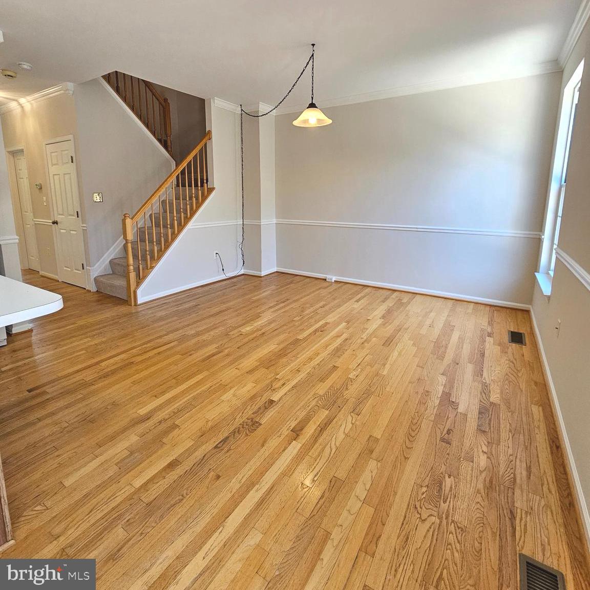 21674 Frame Square Broadlands, VA 20148 - Photo 20 of 43 a view of an empty room with wooden floor and a chandelier