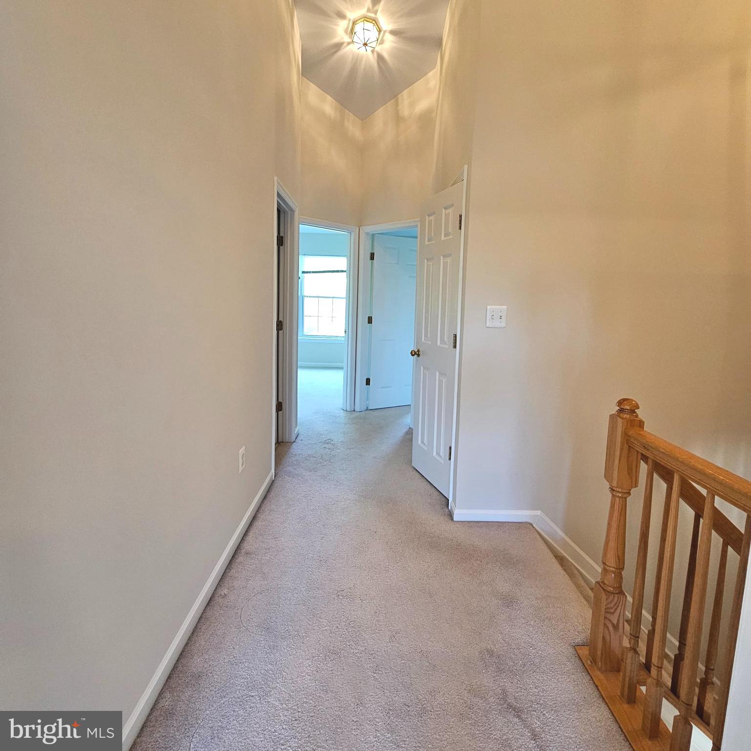 21674 Frame Square Broadlands, VA 20148 - Photo 30 of 43 a view of a hallway with a chandelier fan and wooden floor