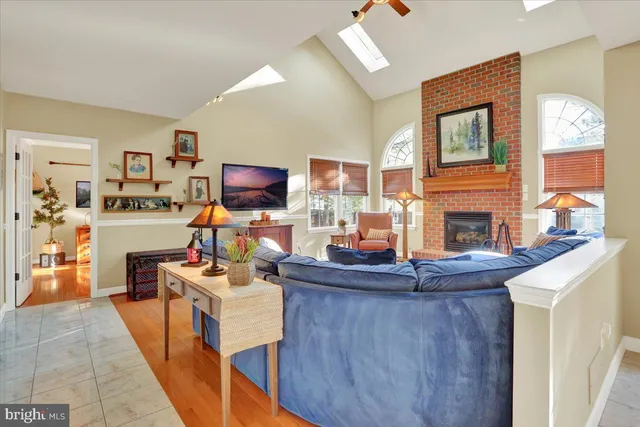 a living room with furniture a large window and a fireplace