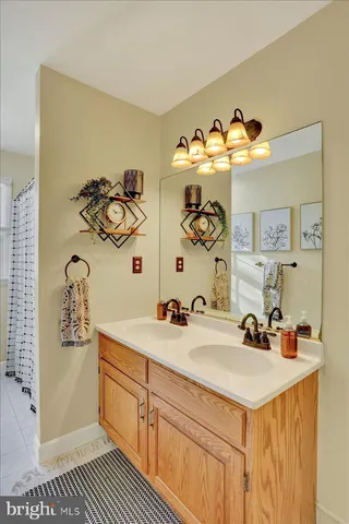 a bedroom with a bed and a dresser with mirror