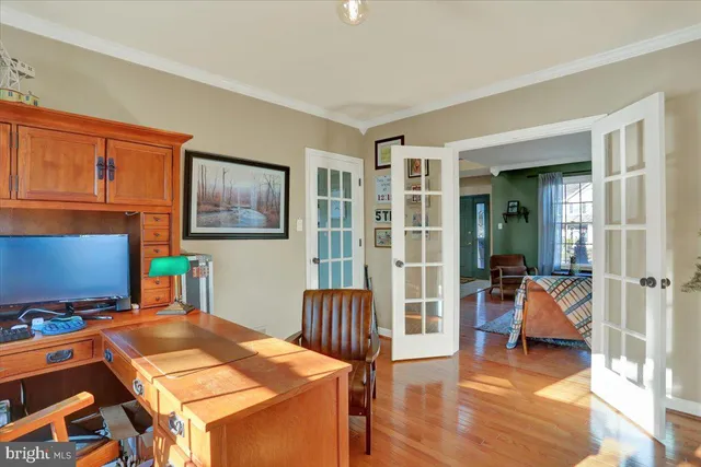a living room with furniture and a dining table